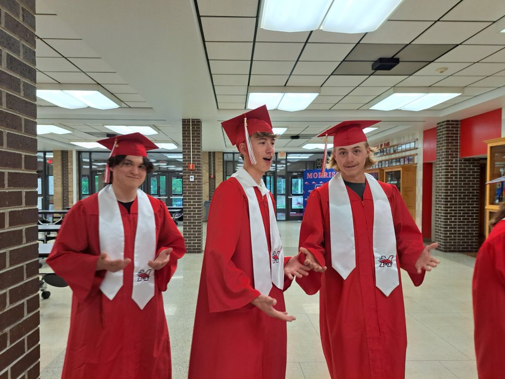 MHS seniors participate in the "six, seven" trend as they approach the gym prior to the ceremony; photo courtesy of Mr. Brian Bartoz.