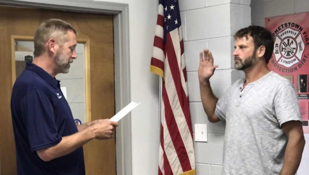 Board President Tony Wade, left, administers the Oath of Office to Corbin Anderson at Monday night's board meeting.