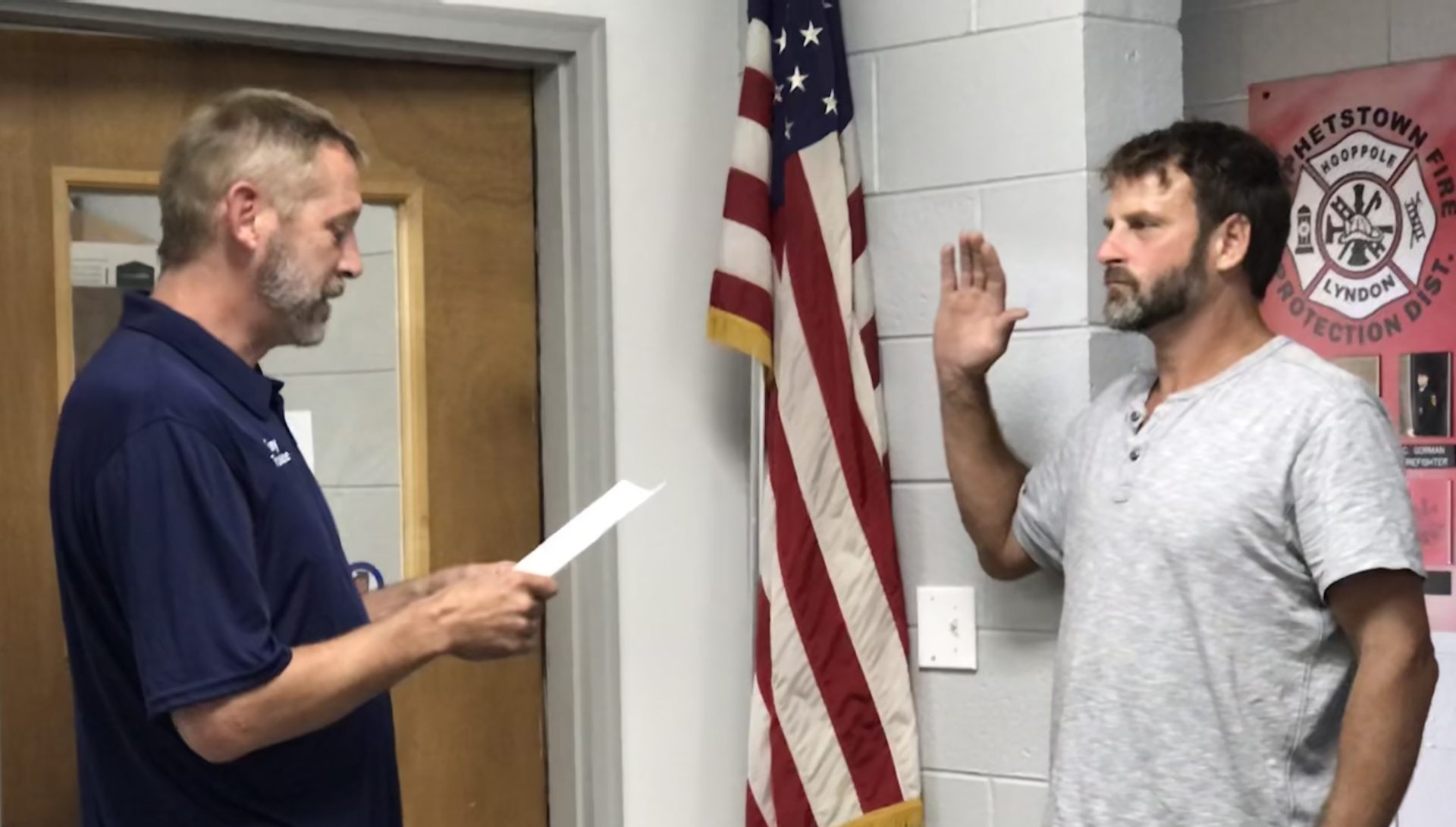 Board President Tony Wade, left, administers the Oath of Office to Corbin Anderson at Monday night's board meeting.