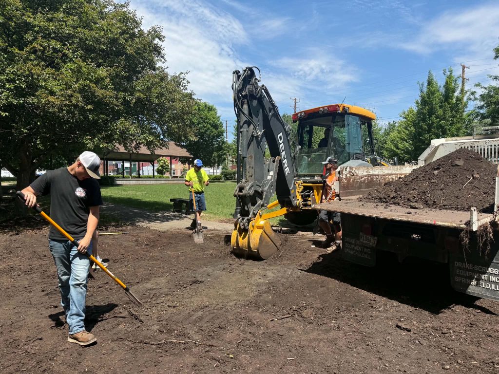 Gavin VanDyke, left, works on his Eagle Scout project with a small crew at Eclipse Square Park in Prophetstown.